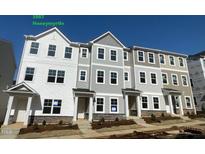 New construction townhomes featuring modern design with varying color schemes and stone accents enhance curb appeal at 3007 Honeymyrtle Ln, Durham, NC 27703