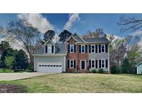 Charming two-story home featuring a two-car garage, brick accents, and a well-maintained front lawn at 3501 Kensett Way, Raleigh, NC 27616