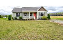 Charming single-story home with a landscaped yard and a inviting front porch at 4275 Hickory Crossroads Rd, Kenly, NC 27542