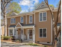 Charming townhome exterior featuring a covered front porch and neutral siding at 4447 Antique Ln, Raleigh, NC 27616