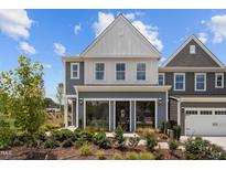 Charming two-story townhouse featuring a beautifully landscaped front yard, complemented by a bright, modern design at 628 Brittany Ct, Durham, NC 27703