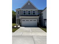 A charming gray two-story home with a large driveway and attached two-car garage at 628 Brittany Ct, Durham, NC 27703
