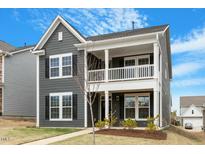 Charming two-story home with a covered porch and a landscaped front yard at 813 James J Freeland Dr, Hillsborough, NC 27278