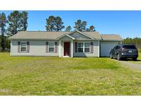 Charming one-story home features a well-maintained lawn and attached garage at 10 Golden Poppy Ln, Youngsville, NC 27596