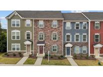Charming townhomes featuring varied facades, manicured lawns, and inviting entrances at 1094 Ambergate Sta, Apex, NC 27502
