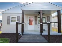 Charming single-story home featuring a covered porch with striking wooden pillars and a well-manicured front lawn at 1220 Garner Rd, Raleigh, NC 27610