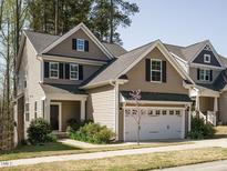 Charming two-story home featuring a two-car garage, well-maintained lawn, and beautiful curb appeal at 2217 Magnolia Tree Ln, Durham, NC 27703
