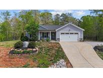 Charming single-story home with well-manicured lawn, landscaping, and attached two car garage at 25 S Treeline Dr, Spring Hope, NC 27882