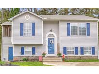 Charming home featuring blue shutters, a welcoming front door, and manicured landscaping at 2816 Delco Ct, Raleigh, NC 27610
