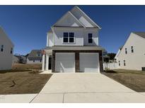 Beautiful two-story home with a two-car garage, brick accents, and a well-manicured lawn on a sunny day at 37 Furley St., Homesite 38, Sanford, NC 27330
