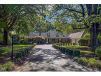 Charming brick home featuring mature trees and a manicured lawn with a long private driveway at 382 Wimbledon Dr, Roxboro, NC 27573