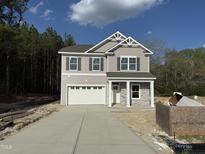 Charming two-story home with a two-car garage and manicured landscaping at 4012 Kingcraig Ln, Zebulon, NC 27597