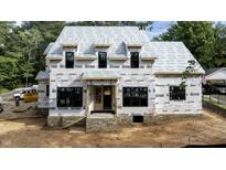 New construction home featuring a modern design with large windows and brick foundation is being built at 5107 Hearth Dr, Raleigh, NC 27609