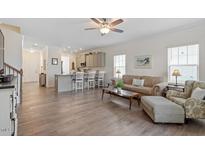 Spacious living room featuring an open-concept kitchen and natural light at 5205 Sorrell Glen Dr, Raleigh, NC 27603