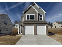 New two-story home with a two-car garage and a concrete driveway at 75 Furley St., Homesite 115, Sanford, NC 27330