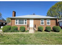 Charming brick home featuring a classic design, well-maintained landscaping, and a welcoming entrance at 807 Everett St, Burlington, NC 27215