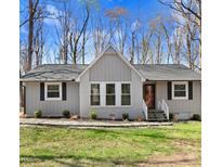 Charming single-story home with a well-maintained lawn, dark shutters, and inviting front entrance at 908 Snow Hill Rd, Durham, NC 27712