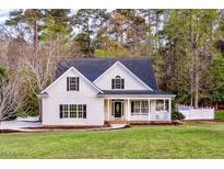 Charming white two-story home with a welcoming front porch and a well-manicured lawn at 924 Elbridge Dr, Raleigh, NC 27603