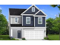 Charming two-story home featuring gray and navy blue siding with a two-car garage at 1009 Shovelhead Dr # 5, Durham, NC 27703