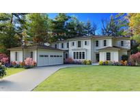 Beautiful two-story home with a three car garage, lush landscaping, and a well-manicured lawn at 1216 Barcroft Pl, Raleigh, NC 27615