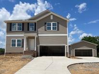 Charming two-story home with a two-car garage and neutral siding, perfect for modern living at 15 Atherton Circle, Angier, NC 27501