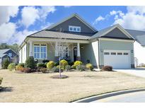 Charming one-story home with a metal roof, manicured lawn, and a welcoming front porch at 208 Evanview Ct, Apex, NC 27523