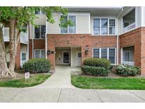 Inviting brick condo building with well-manicured landscaping and visible unit numbers at 217 Waterford Lake Dr, Cary, NC 27519
