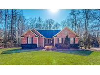 Charming single-story brick home with a well-manicured lawn and mature landscaping at 2440 Helena Moriah Rd, Timberlake, NC 27583