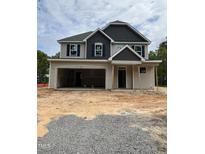 Two story home with large garage and craftsman design details under construction with dirt front yard at 268 Dove Rd, Cameron, NC 28326