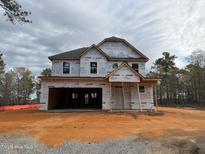 Exterior view of a new two story home featuring a two-car garage and covered porch at 268 Dove Rd, Cameron, NC 28326