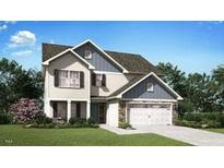 Charming two-story home features a well-manicured lawn, two-car garage, and classic architectural details at 310 Shiloh Way, Mebane, NC 27302
