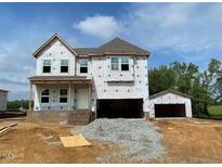 New home construction with a detached garage awaiting finishing touches in a suburban neighborhood at 39 Atherton Circle, Angier, NC 27501