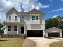 New two story home with attached and detached garages, manicured lawn, and white siding at 39 Atherton Circle, Angier, NC 27501