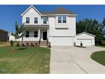 Beautiful two-story home with a two-car garage and landscaped front yard at 39 Atherton Circle, Angier, NC 27501