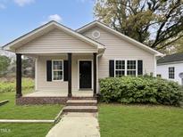 Charming single story home with a well manicured lawn and classic architectural details at 414 Longfellow St, Fuquay Varina, NC 27526