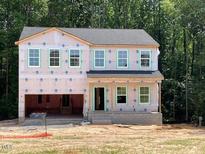 Two-story home featuring multiple windows ready for siding and other exterior finishes at 46 Atherton Circle, Angier, NC 27501