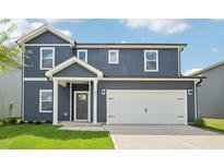 Two-story home featuring a two-car garage and blue siding, and a well maintained lawn at 601 White Birch Ln, Angier, NC 27501