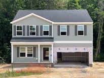 Two-story home featuring gray siding, dark shutters, and a spacious two-car garage awaiting customization at 62 Atherton Circle, Angier, NC 27501