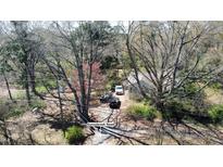 Aerial view of a charming home with mature trees and a driveway leading to Sunnybrook Road at 620 Sunnybrook Rd, Raleigh, NC 27610