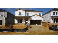 New home under construction featuring a brick-accented front porch and Tyvek home wrap at 621 White Birch Ln, Angier, NC 27501