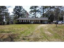 Charming single-story brick home with white trim, a spacious yard, and a private driveway at 640 Sunnybrook Rd, Raleigh, NC 27610