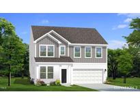 Charming two-story home with a mix of vertical and horizontal siding, complemented by lush landscaping at 766 Old Station Pointe, Angier, NC 27501