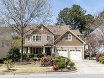 Charming two-story home with a well-manicured lawn, inviting front porch, and attached two-car garage at 921 Marshall Farm St, Wake Forest, NC 27587