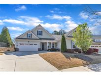 Charming single-story home with an attached two-car garage, a well-manicured lawn, and inviting curb appeal at 1038 Branwell Dr, Durham, NC 27703