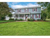 Charming blue two-story home featuring a welcoming front porch, red shutters and well-manicured lawn at 108 Birdie Ct, Rocky Mount, NC 27804