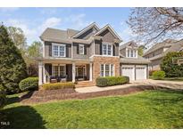 Charming two-story home featuring a stone and siding facade, well-manicured lawn and a two car garage at 1204 Croydon Glen Ct, Cary, NC 27519
