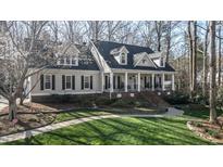 Charming home featuring a manicured lawn, complemented by a two-story facade and a welcoming front porch at 1229 Westerham Dr, Wake Forest, NC 27587