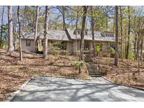 Charming home nestled in a wooded lot with a bright green front door, offering a serene and private setting at 1516 Cumberland Rd, Chapel Hill, NC 27514