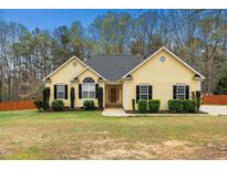 Charming yellow ranch-style home with well-maintained landscaping and a classic design at 1638 Crystal Ln, Stem, NC 27581