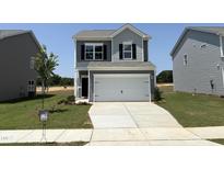 Charming two-story home featuring gray siding, a two-car garage, and a well-manicured front yard at 168 Bruce Dr, Dunn, NC 28334